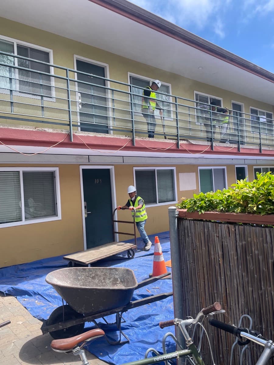 Junk Tigers crew demolishing apartment walkway decking in Orange County